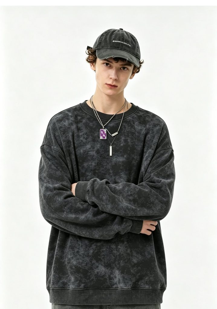 Acid-wash black crewneck sweatshirt worn by a model