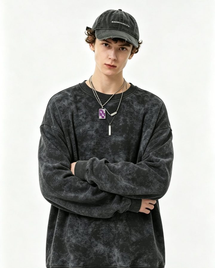 Acid-wash black crewneck sweatshirt worn by a model