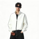 Bone full-zip track jacket with black piping, worn by a model