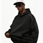 Black heavyweight pullover hoodie worn by a model, front view