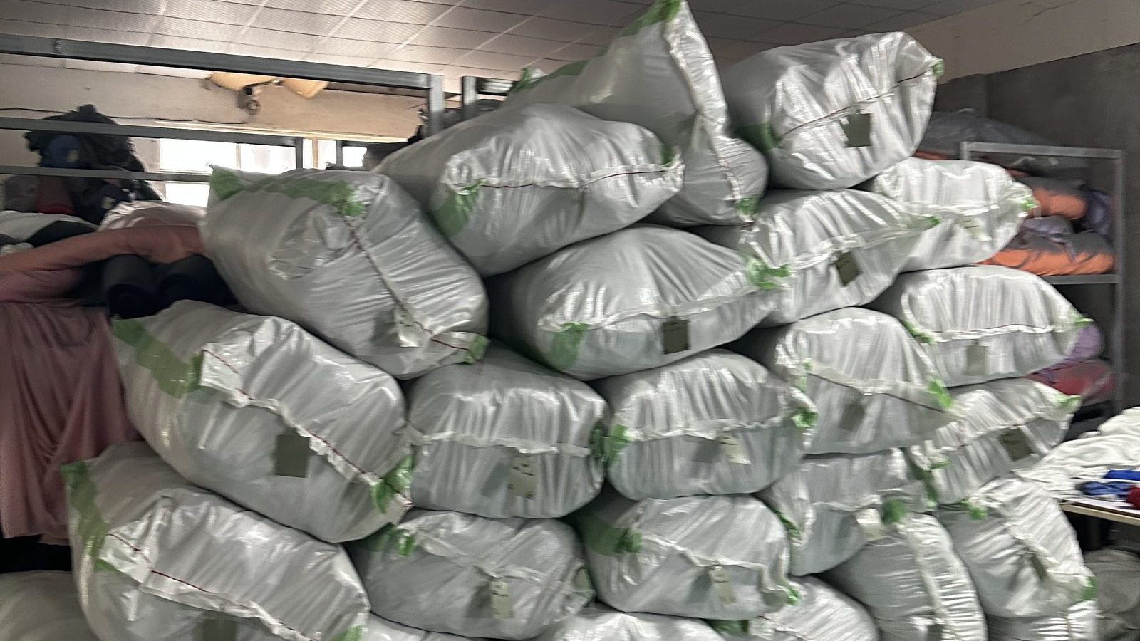 Pile of individually bagged garments waiting for carton packing