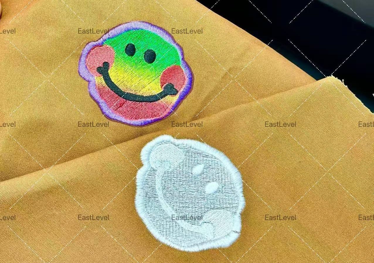 Puff and flock print patches on a garment next to a heat press