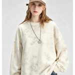 Washed cream crewneck sweatshirt worn by a model