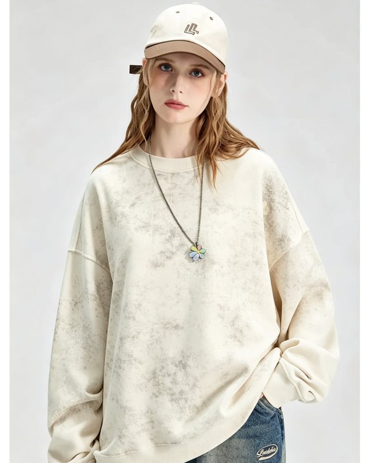 Washed cream crewneck sweatshirt worn by a model