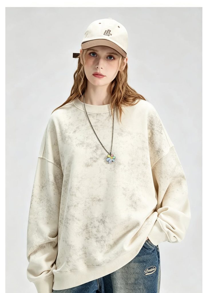 Washed cream crewneck sweatshirt worn by a model