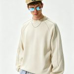 Cream raglan sweatshirt shown from a second angle
